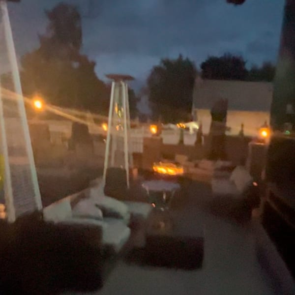 The Palazzo Ristorante's outdoor patio at dusk, with glowing string lights, fire pits, and lounge seating.